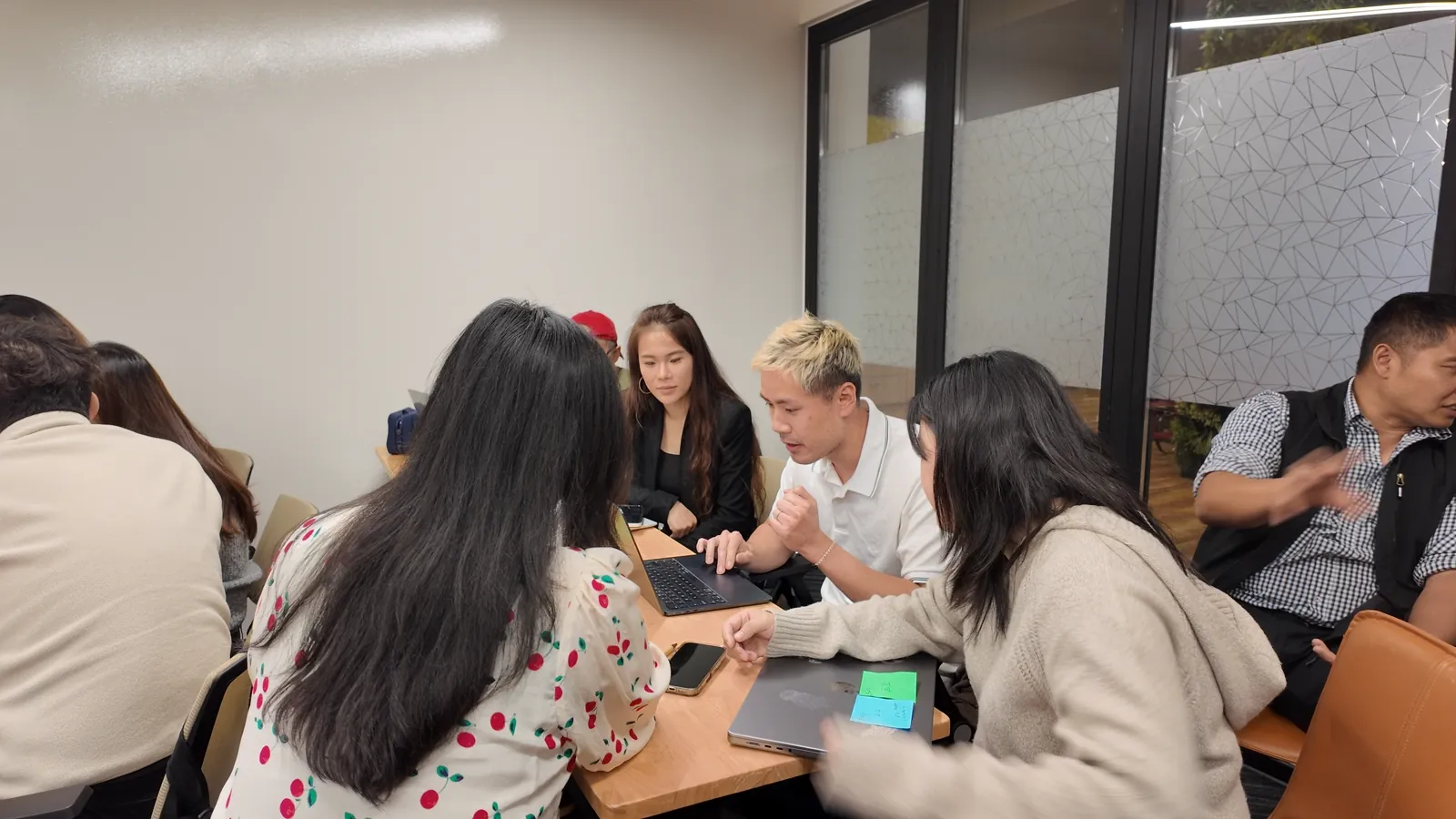 A hackathon team working through a workflow on laptops